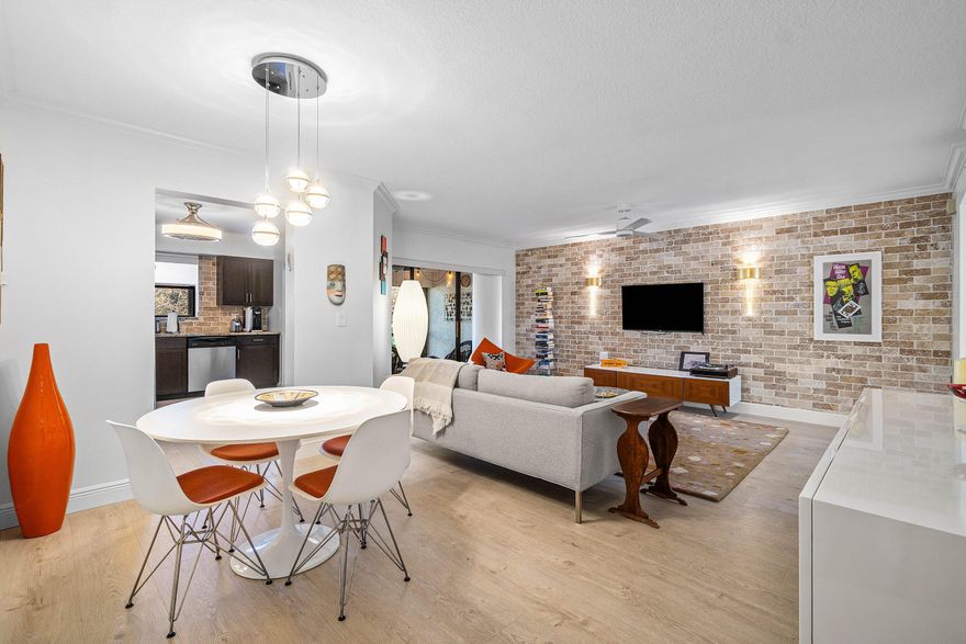 This stunning 2/2 condo w/ 1 car garage is very bright, pristine and features tons of character like a condo in SOHO w/ a peaceful lake view. Custom design features such as exposed brick, upscale window treatments & custom lighting!  Coastal style luxury wood look flooring throughout and can be sold beautifully furnished.  The kitchen has mahogany cabinets, granite countertops & S/S appliances. The Primary Bedroom is extremely spacious, features a sitting area or room for a desk/office area w/ views out to the lake and a custom fitted closet!  The Primary Bathroom has dual sinks & Roman soaking tub/shower. Relax on the screened lanai w/ an amazing long lake view & peaceful sounds of the fountain.  The clubhouse has a fitness room, show hall, billiards, pickleball & tennis, dog run!