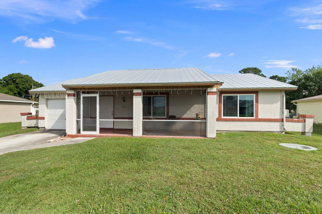 Photo of 731 NW Bayard Avenue, Port Saint Lucie, FL 34983 (MLS # R10970861)