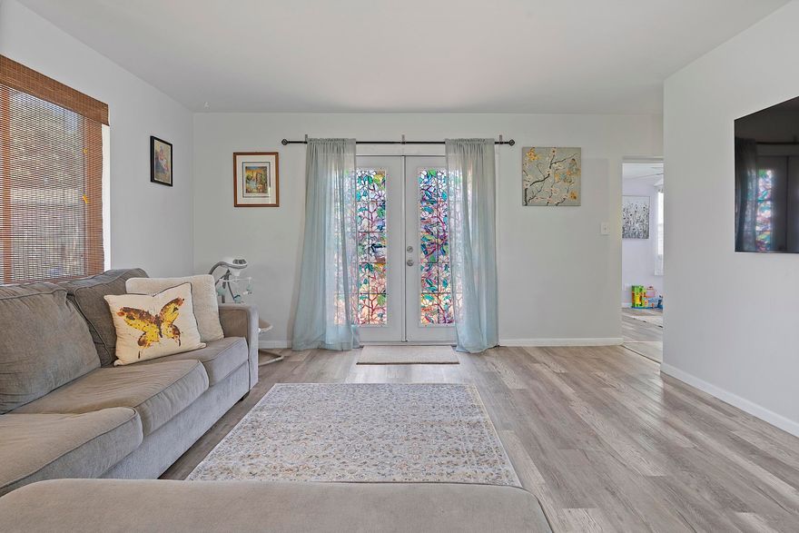 TOTAL PRICE IMPROVEMENT OF $19,910.  $317,000 ASSUMABLE LOAN AT 5.15%.  After purchasing this home in late 2022 and completing numerous upgrades, the sellers are ready for their next chapter — more space for their growing family!  This creates an incredible opportunity for buyers to step into a truly move-in-ready home. Whether you're a first-time buyer or a savvy investor, this property offers exceptional value with major improvements already in place. Plus, several first-time homebuyer programs may allow you to purchase with minimal out-of-pocket costs. Inside, you'll find thoughtfully curated updates throughout, including impact windows for peace of mind, a new front door, updated flooring, and fresh interior and exterior paint that give the home a clean, modern aesthetic.  The big-ticket items have already been taken care of, featuring a new roof, new attic insulation, a new A/C unit and air handler, a tankless water heater, and a state-of-the-art front-loading washer and dryer — all designed to provide long-term value and minimize maintenance concerns. A standout feature is the solar panel system, keeping electric costs remarkably low at approximately $40 per month (grid connection fee only). In today's market, that level of efficiency is a major advantage. Step outside to enjoy a fully fenced backyard offering privacy and security — ideal for pets, children, entertaining, or simply relaxing. The newly installed deck awning provides the perfect shaded retreat to enjoy Florida's outdoor lifestyle year-round. One of the most unique features of this home is the approximately 378 sq. ft. garage conversion, currently configured as a fully functional efficiency complete with its own bathroom and kitchenette. This versatile space is perfect for an in-law suite, accommodating extended family, providing independence for a young adult, or generating rental income (annual rental or Airbnb). With no HOA and dedicated space to store a boat or RV — tucked away yet easily accessible — this property offers flexibility that's hard to find. Whether you're looking for your first home, a multi-generational setup, or an income-producing opportunity, this home truly checks all the boxes. Don't miss your chance to own a well-updated, energy-efficient property with flexibility, value, and room to grow.