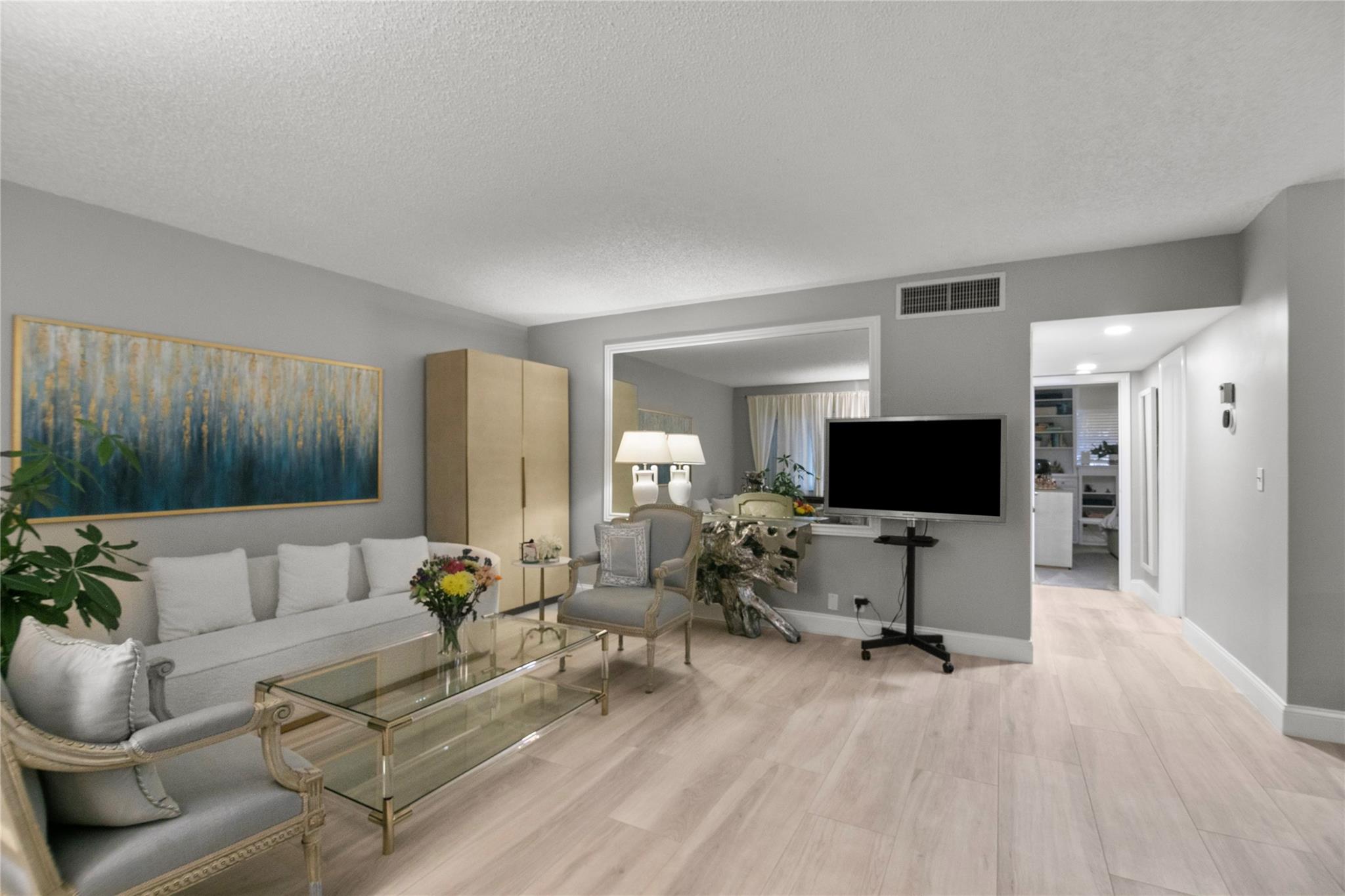 Welcome to this move-in ready 2-bedroom, 2-bath condo offering 1,200 sq. ft. of spacious living in the heart of Imperial Point. Just 2 miles from the beach and 4 blocks from Imperial Point Hospital, with shopping and dining nearby. This bright unit features impact windows, laminate flooring, crown molding, full-size washer and dryer & custom closets. The modern kitchen includes stainless steel appliances, and both bathrooms have been updated with new vanities and lighting. Enjoy a resurfaced, heated saltwater pool with a new deck and fence. Assigned parking is right outside the door, and extra storage is included. The building passed its 40-year inspection, has a newer roof, no pending assessments. Located in a quiet, well-maintained community, this condo is the perfect place to call home!