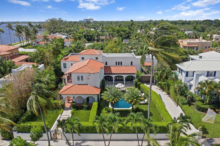 Villa Belmonte is a beautifully renovated 1920's Spanish Mission style estate in the lake block of El Cid. This private gated home is surrounded by lush landscaping and sits at a high elevation. Enter into a stunning foyer with soaring ceilings accented with pecky cypress beams and a grand staircase. This home boasts an elevator, formal living & dining rooms, gourmet kitchen and spacious family room. Upstairs there are 4 large bedroom suites with custom California Closets, three with private balconies. This professionally decorated home also features a 2 car attached garage with workshop, impact windows and doors, 3 new zoned AC units, pool, new artificial grass, new pool fence, hard wood and terracotta tile floors and a downstairs suite with separate entry.