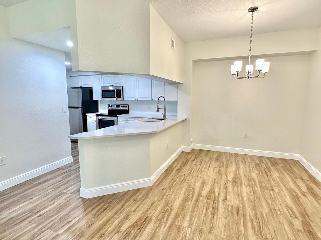 Photo of 3018 Alcazar Place #106, Palm Beach Gardens, FL 33410 (MLS # R11081008)