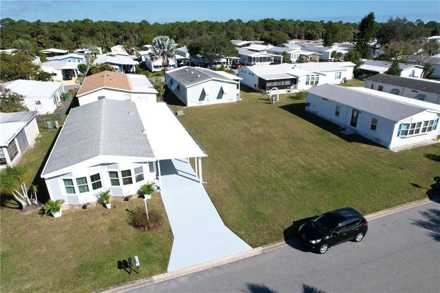 This TURN KEY, DOUBLE LOT, Basks in Barefoot Bay Sunshine all day long! Abundance of Sun and Palm cast into the home's entryway, featuring a game room and Pool Table. Luxury Hardwood Flooring, New Carport, Workshop, A/C 2020, Roof 2021, Upgraded Pipes 2024 and More. Turn additional lot into pool, garage or a second oasis home. Amazing amenities including, 3 pools, clubhouse, tennis/pickle ball, beach access at the private Barefoot Bay Beach off A1A. Barefoot Bay is a deed restricted community, not an HOA. Fees are paid annually in the tax bill. A one time fee $1551.50 is due at closing