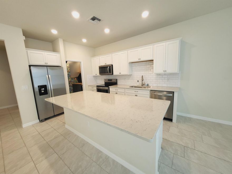 Beautiful 3-bedroom, 2.5-bath townhouse with a 2-car garage in a quiet gated community. Enjoy the community pool and outdoor gym, perfect for an active lifestyle. The spacious kitchen features a large island, bar, and wine cellar--ideal for cooking and entertaining. The primary suite includes dual sinks, a walk-in closet, and a relaxing en-suite bathroom. Conveniently located near I-95, the Turnpike, outlet shopping, restaurants, and more. Stylish comfort in a great location.