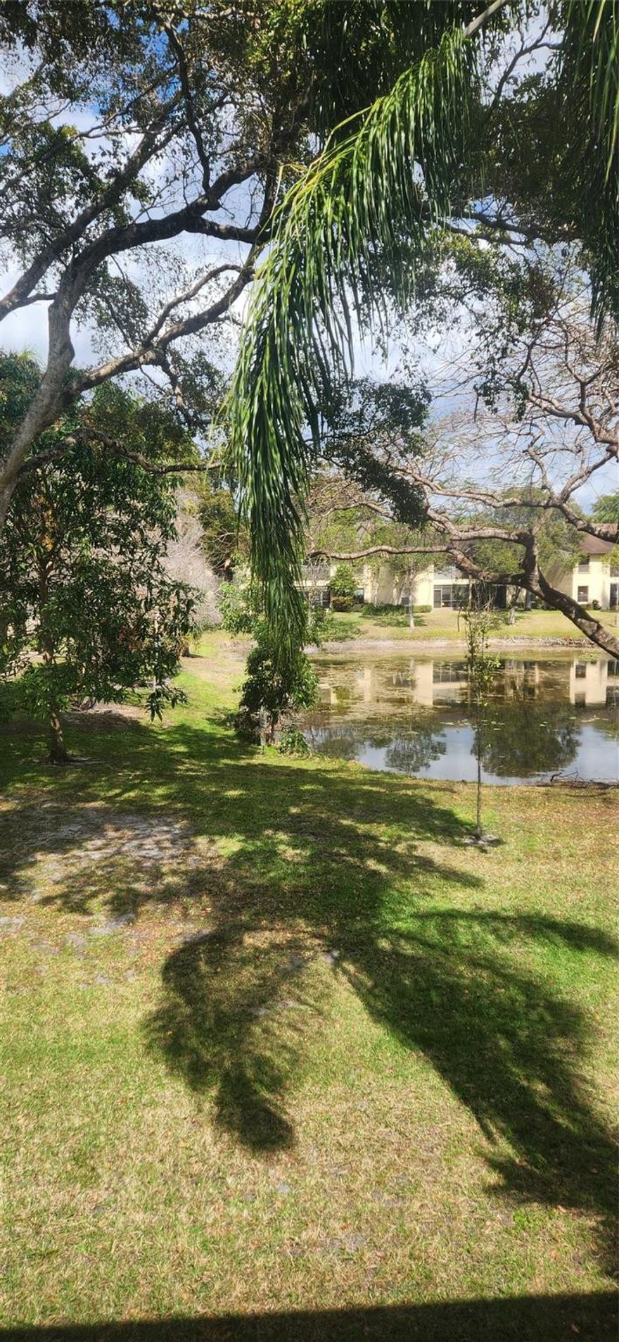 If you are looking for cozy, tucked away private and quiet- this can be your new HOME.  A serene lake view off your balcony to enjoy your morning coffee or evening beverage! Crown molding and neutral painted walls with vaulted ceilings in the family room. Kitchen boasts granite and wood cabinets and a pantry with roll out drawers. Large walk in closet in the primary suite. Unit has a stacked washer/dryer. Front door parking in the first spot! No long walks to your front door! IMPACT WINDOWS. This unit has one of the lowest condo fees in the Township! Close to the Promenade with restaurants and shopping, nearby parks, natural trails in the city. You will have access to all the amenities the Township provides!   l