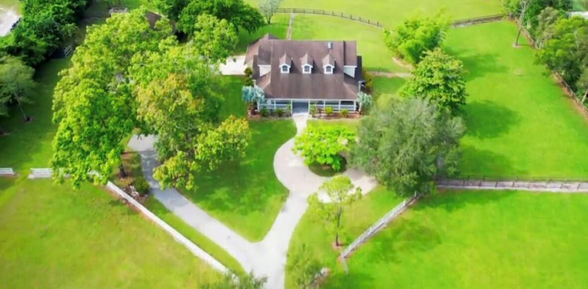 This beautifully maintained estate home features 6 generously sized bedrooms and 4 full bathrooms across approximately 3,900 square feet of living space. Inside, you'll find soaring ceilings, a grand double-height foyer, an open-concept layout, abundant natural light, walk-in closets, and tasteful finishes throughout. Can be rented furnished and unfurnished.Set on expansive, fenced grounds with lush landscaping and wide-open spaces, the property offers a rare sense of peace and privacy--perfect for families, remote professionals, or anyone seeking a serene retreat in one of Wellington's most sought-after areas. A two-car attached garage and circular driveway provide ample parking.Please note the barn is not rented and is not part of the rental. No horses or agriculture.