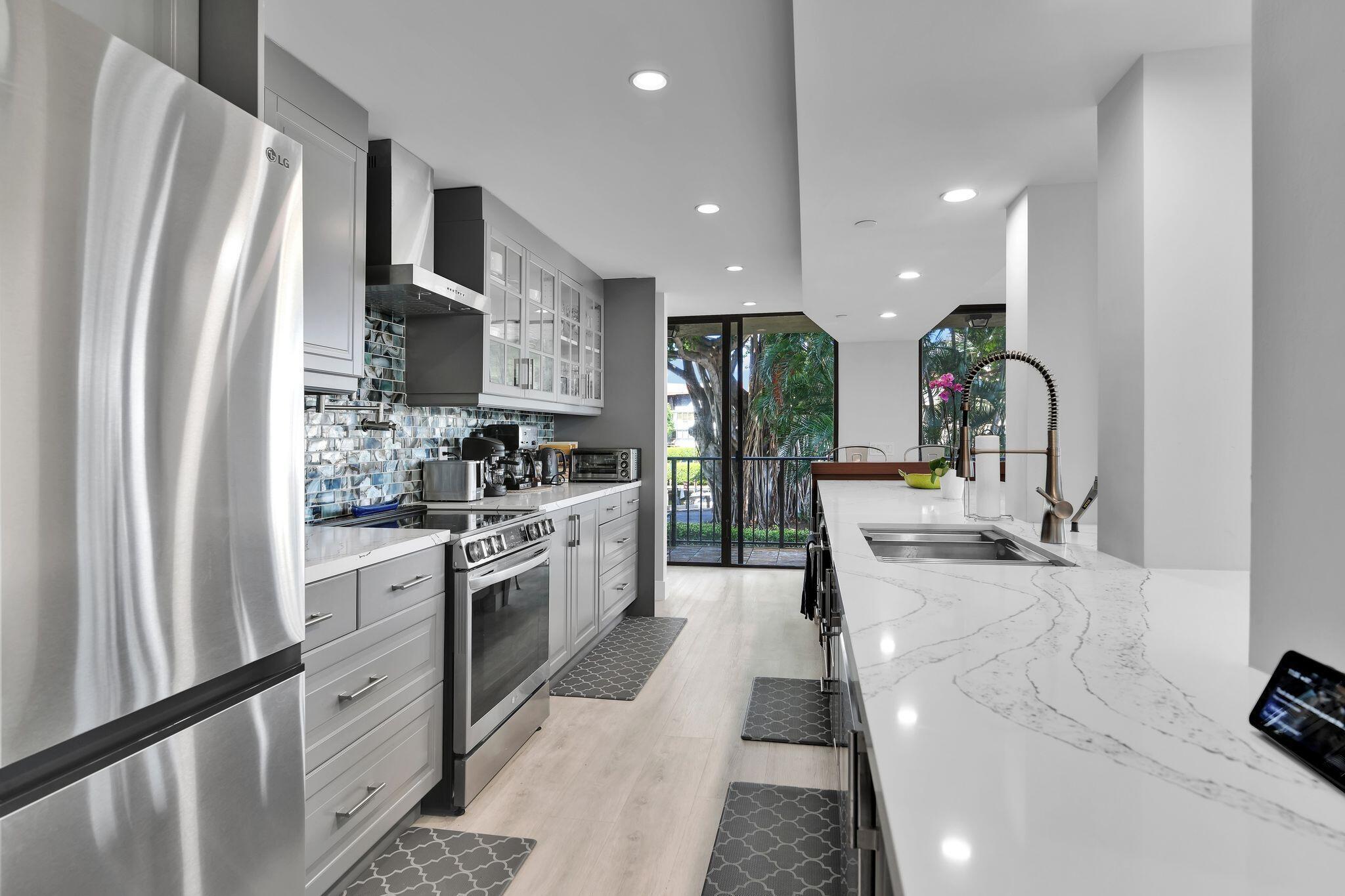 SPECTACULAR, 3BR 2BA - North West - East Corner Condo in highly sought after NEWLY RENOVATED Porta Bella Yacht and Tennis. This designer renovated apartment is a must see, and sure to impress. Enjoy an open concept kitchen with spectacular views of Canals and tranquil banyan tree. This corner apartment offers two LARGE spacious balconies. Porta Bella East offers many amenities such as 2 PICKLEBALL, 2 TENNIS COURTS, 2 fitness facilities, LARGE Kidney shaped pool overlooking the over 300 feet of intracoastal. The manicured lush green landscaping, & canopies all overlooking the intracoastal make Porta Bella truly a one of a kind Hidden Secret of Boca Raton. Enjoy Boca 7 min to Spanish River Beach. Mizner Park is 8 minutes away and Popular Atlantic Ave is just a 10 minute drive.