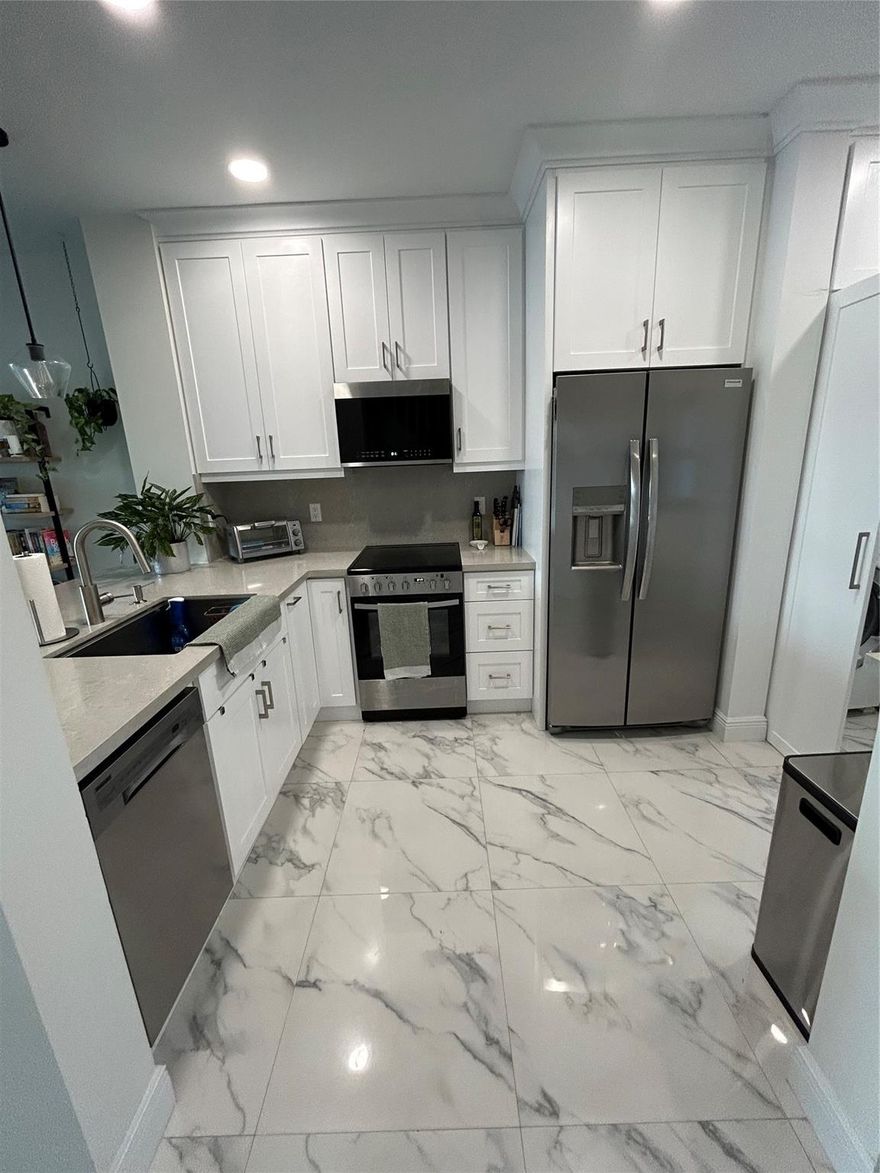 Enjoy lakefront living in this beautifully renovated 2-bedroom, 2.5-bathroom townhome featuring en-suite bedrooms with walk-in closets & thoughtful updates throughout. The home boasts a brand-new kitchen with modern finishes, updated bathrooms, new flooring, upgraded lighting, & hurricane impact windows. 
The kitchen includes a spacious bar w/ built-in storage underneath—perfect for both entertaining and functionality. Additional smart storage beneath the stairwell. Backyard has low-maintenance turf overlooking the tranquil lake.
Parking is easy with a 2-car driveway and guest parking conveniently nearby. Enjoy the community pool, gym, tennis, and rec center. Community is gated. Move in available Dec. 1, 2025.