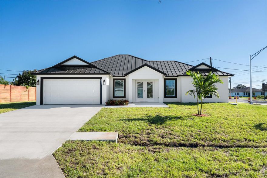 Step into luxury and style in this beautifully designed new construction home. Featuring a sleek Standing Seam metal roof, PGT Impact windows and doors, spray foam insulation (even the garage) and oversized driveway. Wide open concept living area with high ceilings, gorgeous large porcelain tile flooring throughout for a bright and seamless finish. This home is move-in ready and perfect for anyone looking to enjoy a low-maintenance, high-style lifestyle. Located in a growing neighborhood close to shopping, schools, and easy access to the Turnpike and I-95.