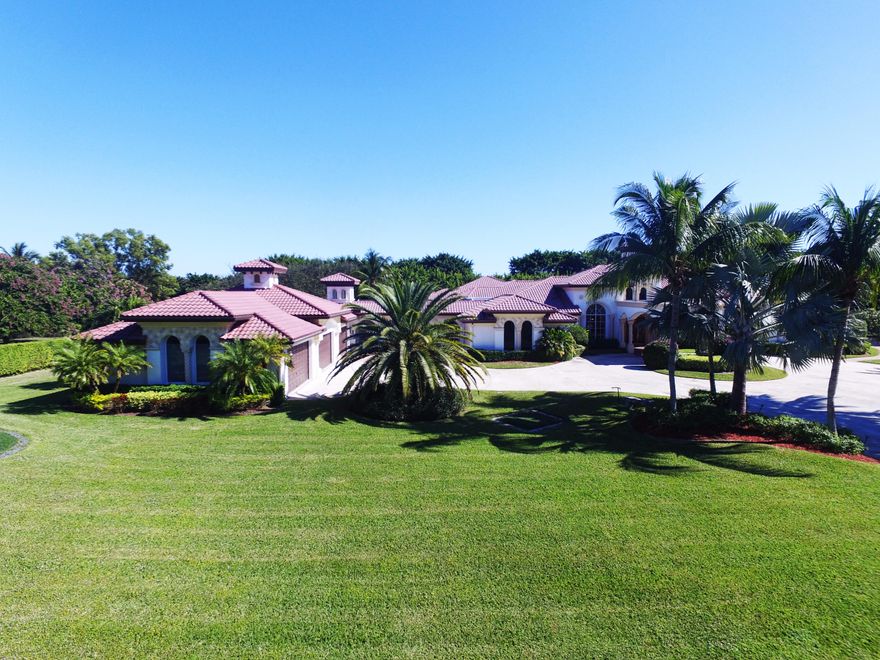 EXQUISITE ESTATE RESIDES ON 3.4 ACRE LAKE FRONT SITE. ENJOY YOUR RECENTLY ADDED ALL PURPOSE PAR 3 GOLF COURSE PLUS PRIVATE TENNIS/SPORTS COURT ON YOUR OWN PROPERTY! LIGHTED FOUNTAIN. PORTE COCHERE ENTRY WITH CUSTOM MAHOGANY DOORS. SOLID WOOD CABINETRY THROUGHOUT WITH GRANITE AND MARBLE TOPS. **NEWER CUSTOM AMAZING MOVIE THEATRE HAS BEEN RECENTLY ADDED. CUSTOM BUILT INS INCLUDE CHERRY WOOD LIBRARY/OFFICE, STAND UP WET BAR, EXERCISE ROOM, KIDS DEN PLAYROOM.  EXTENSIVE USE OF NATURAL AND FAUX COLUMNS. COVERED SATURNIA OUTDOOR WETBAR AND BBQ. LARGE 20X40 POOL WITH 5 LIGHTED FOUNTAINS AND SPILLWAYS. 6 CAR GARAGE. ZONED FOR BOCA SCHOOLS AND  CONVENIENT TO SHOPPING AND TURNPIKE. INFORMATION DEEMED RELIABLE AND SUBJECT TO CHANGES, OMISSIONS & ERRORS WITHOUT NOTICE. ALL MEASUREMENTS ARE APPROXIMATE