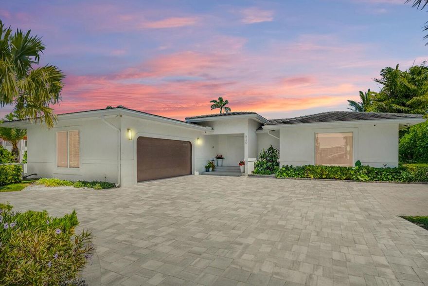 Experience luxury island living in this fully renovated 4-bed, 2.5-bath waterfront retreat on exclusive Hypoluxo Island. Spanning 2,726 sqft, this home features vaulted ceilings, impact windows, upgraded 4x4 porcelain floors, and a redesigned chef's kitchen with Miele appliances, gas stove, and integrated espresso machine. The primary suite offers spa-style finishes, custom closets, and pool views. Enjoy a heated saltwater pool, sauna, and cold plunge, all set against lush landscaping for total privacy. Entertain on the expansive deck or launch from your new dock with 16,000lb boat lift and jet ski storage. Whole-home generator, 3-zone AC, water filtration, and custom furnishings complete this rare offering.Offered fully furnished--schedule your private showing today.