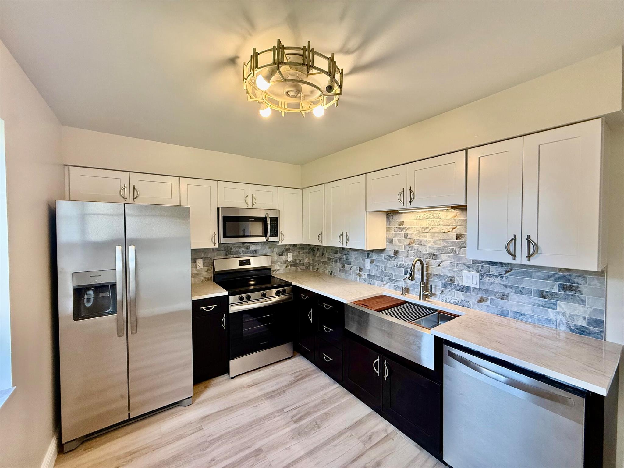 ABSOLUTELY GORGEOUS & Beautifully renovated 2/2 first-floor corner unit in the gated Island House Condominiums! Only corner units feature two patios, offering cross-breezes and pond views. Entire unit and patios have all-tile flooring popcorn removed with sleek knockdown ceilings, plus all new light fixtures & fans including a stylish boho fan in the kitchen. The kitchen shines with quarzite countertops, farmhouse sink, Moen faucet, white shaker uppers, espresso lowers, and brand-new stainless steel appliances. Both bedrooms are masters with updated baths featuring hand-selected vanities, modern mirrors, and designer fixtures. Community perks: all-age living, pool & clubhouse, 1 assigned parking spot, gated security, small pet allowed. Steps to the pool and minutes to Downtown Fort Pierce