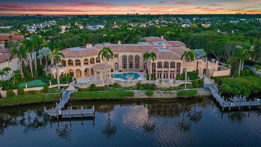 Introducing a palatial waterfront estate on a double lot in the exclusive community of Admirals Cove, where timeless design meets South Florida luxury. Situated on over 300 feet of prime water frontage with two private docks, this architectural masterpiece offers 9 bedrooms, 13 baths, and a lifestyle defined by elegance and ease. Ideal for yacht owners and water enthusiasts, the property offers exceptional access and capacity for large vessels or multiple watercrafts. Every detail of the interior has been thoughtfully curated—from soaring ceilings and rich finishes to spacious living areas designed for both grand-scale entertaining and private retreat. . A dedicated 3-bedroom guest house ensures comfort and privacy for extended family or visitors,   SEE MORE... while the 6-car garage provides ample space for car collectors and enthusiasts. The estate is a dream for entertainers, with a complete catering kitchen and wet bar, a formal dining room fit for large gatherings, and a club room upstairs featuring warm wood finishes, multiple seating areas, custom wood walls all overlooking breathtaking Intracoastal views. Enjoy alfresco dining by the water or unwind poolside surrounded by tropical serenity. Admirals Cove is one of Jupiter's most sought-after gated communities, known for its luxurious waterfront lifestyle, 45 holes of championship golf, tennis, a world-class marina, and a private country club with five-star amenities. Located in the heart of Jupiter, FL, residents enjoy easy access to pristine beaches, top-rated schools, fine dining, and everything that makes this coastal town one of Florida's most desirable places to live.