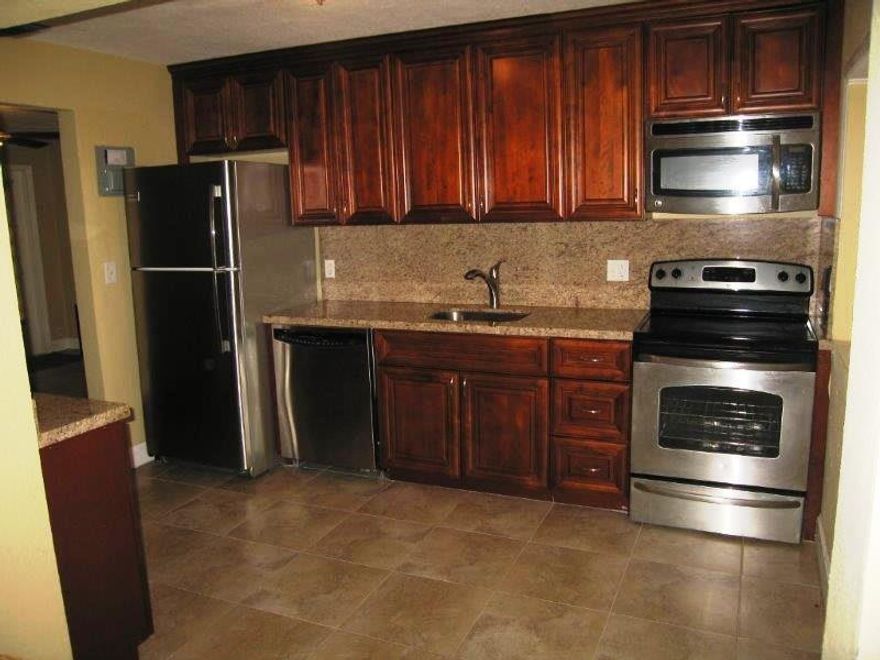 Please excuse the photos. Tenant has been renting for 10 years. The interior and exterior are scheduled to be painted. The interior will be a contemporary off-white color.  This beautiful home features stainless appliances, granite countertops, ceramic tile floors, a separate family room, Central A/C, dishwasher, washer and dryer and a sparkling pool. The property sits on a huge 12,000 sq. ft. fenced lot. Perfect for living and entertaining. It is conveniently located close to I-95 and a short drive to the beach.