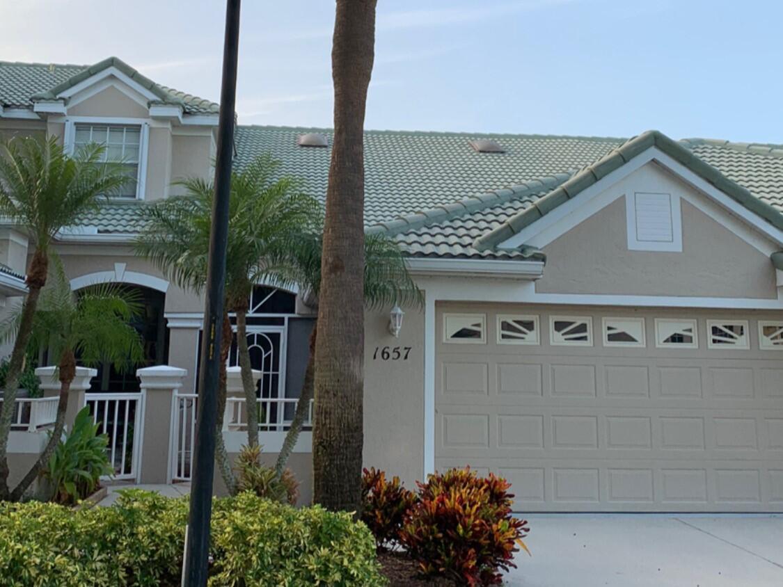 Beautiful lakefront townhome in the highly desirable Lake Charles community of St. Lucie West. This 2-bedroom, 2-bath home with a 2-car garage features stunning lake views, soaring 18' vaulted ceilings, accordion shutters, and a whole-house water filtration system. Enjoy peaceful mornings on the screened porch overlooking the serene lake. Lake Charles offers resort-style amenities, including a clubhouse, pool, hot tub, tennis, pickleball, playground, and scenic walking trails. Non-motorized boating is welcome on the community's pristine lakes. Basic cable is included, and the HOA covers exterior roof maintenance. Conveniently located near shopping, dining, and recreational activities.