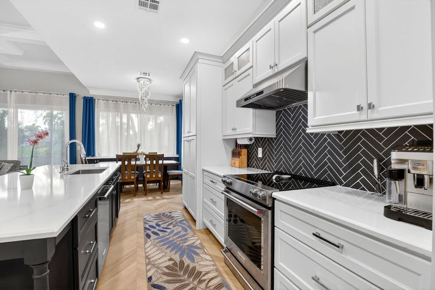 Welcome to this meticulously updated, move in ready 3-bedroom 2-bathroom home with a 2-car garage in Polo Trace, Delray Beach, FL. Lots of pickleball here!

**THIS IS THE ONLY ALL AGE GATED COMMUNITY IN SOUTH PALM BEACH COUNTY**

From the moment you arrive, the home showcases exceptional curb appeal, featuring a gray tile roof, beautifully maintained low maintenance landscaping, and a center lake view with fountain, creating a serene and inviting first impression.

Step inside to a bright open concept floor plan designed for everyday comfort and seamless entertaining. 

Elegant light toned herringbone flooring, tray ceilings, and custom crown molding throughout create a cohesive, upscale feel, while stylish designer lighting and 19 recessed lights add warmth and character to each s At the heart of the home is a stunning chef inspired gourmet kitchen that perfectly blends style and functionality. The space features crisp white cabinetry, premium quartz countertops, a dramatic black herringbone backsplash, and a large center island ideal for gathering and entertaining. High end stainless steel appliances, a built in wine cooler, and generous prep space make this kitchen perfect for both casual meals and hosting guests. The kitchen flows effortlessly into the spacious dining area and sun filled living room, creating a seamless layout ideal for modern living.
The inviting living area is anchored by a sleek contemporary fireplace and framed by large sliding glass doors that flood the space with natural light while offering a beautiful transition to the outdoor living area. A versatile home office or flex space with custom built ins and elegant wainscoting provides the perfect setting for remote work, reading, or creative pursuits.
The primary suite serves as a private retreat, featuring a calming color palette, a stylish paneled accent wall, and elegant lighting that enhances the tranquil atmosphere. The spa inspired primary bathroom offers a luxurious escape with a frameless glass walk in shower, modern soaking tub, dual vanities with designer mirrors, and floor to ceiling tile finishes. A custom walk in closet with built in shelving and storage provides ample space to keep everything beautifully organized.
Additional bedrooms are thoughtfully designed with ample natural light, stylish finishes, and comfortable layouts, perfect for family members, guests, or additional workspace. A well appointed guest bathroom with modern fixtures and classic subway tile completes the interior living spaces. The dedicated laundry room features custom cabinetry, a countertop workspace, and full size front loading washer and dryer for added convenience.
Step outside to your own private screened in outdoor oasis designed to maximize the Florida lifestyle. This expansive screened patio and outdoor living area creates a seamless extension of the home and offers the perfect space for relaxing or entertaining year round. The highlight is a fully equipped built in outdoor kitchen featuring a flat top grill, beverage cooler, and ample prep space, all complemented by modern finishes and thoughtful design. Ceiling fans and the screened enclosure allow you to enjoy the fresh Florida breeze while taking in the peaceful views of lush greenery and mature landscaping.

Polo Trace is one of the most desirable gated communities in west Delray Beach, offering a resort style lifestyle in a beautifully maintained community. Located off Hagen Ranch Road just west of the Florida Turnpike, the community features lush tropical landscaping, scenic lakes, and a peaceful residential setting while remaining close to everything South Florida has to offer.
At the center of the community is an impressive 26,000 square foot clubhouse set within more than seven acres of resort style amenities designed for recreation, fitness, and social activities. Residents enjoy multiple swimming pools, a state of the art fitness center, tennis and pickleball courts, bocce courts, basketball courts, walking and biking trails, and an on site restaurant and bar. A full calendar of social events and clubs creates an active and welcoming community atmosphere.
Polo Trace offers country club style amenities without mandatory golf or membership fees and features a variety of single family homes surrounded by lakes, landscaped green spaces, and scenic walking paths that enhance the relaxed Florida lifestyle.
The community is ideally located about 15 minutes from the shops, restaurants, and nightlife of Atlantic Avenue and the beautiful beaches of Delray Beach. Residents also enjoy convenient access to Boca Raton, West Palm Beach, and Fort Lauderdale, as well as nearby parks and nature preserves including Green Cay Nature Center and Wakodahatchee Wetlands. With its resort style amenities and prime Delray Beach location, Polo Trace offers the perfect blend of luxury living and everyday convenience.