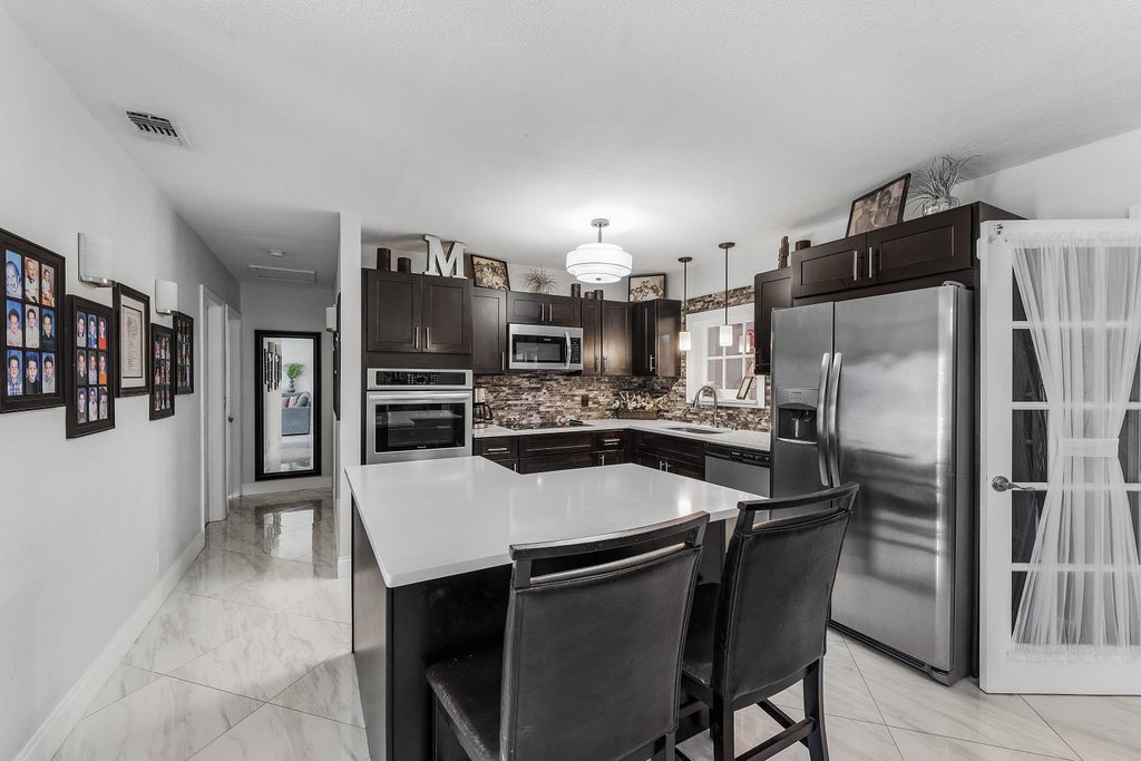 Photo of 517 Ibis Drive, Delray Beach, FL 33444 (MLS # B26079832)