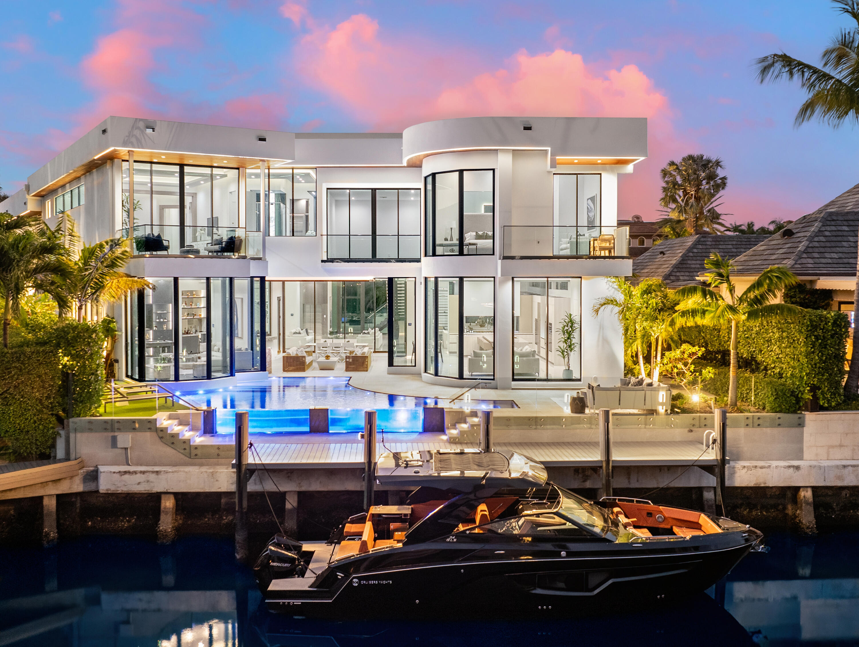 Welcome to Maison de Verre, a contemporary waterfront haven nestled within the prestigious gated community of The Sanctuary in east Boca Raton. This newly constructed estate exudes an air of sophistication, grace, and refined living.Spanning an impressive 13,993 square feet, with approximately 8,826 square feet of meticulously designed interior space, this contemporary masterpiece boasts 7 bedrooms, 8.2 bathrooms, and 65 feet of waterfront frontage.Upon arrival, guests are greeted by a grand entrance featuring soaring 30-foot ceilings, while floor-to-ceiling glass windows invite ample natural light to illuminate the expansive interiors. Art aficionados will appreciate the opportunity to showcase their prized collections.
