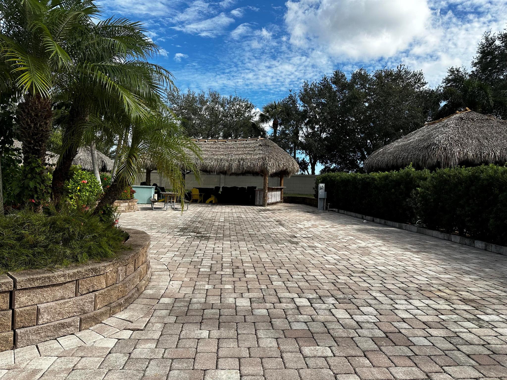 Motorcoach Resort St. Lucie West. Large pavered lot with updated large tiki with extensions (21) and added roll up shades with eisenglass. Plenty of room for the largest Class A motorcoach, vehicles and golf carts. Large outdoor kitchen bar seating, heaters, ceiling fans. This lot has easy access to rear exit of the resort, north pool/spa, laundry and dog wash. Minute walk to the dog park. Located in the Motorcoach Resorts St Lucie West - a class A only resort. Amenities include 18 hole golf, pickleball, pools, spas, tennis, clubhouse, onsite manager with endless activities and social calendar and more! Currently in the rental program.