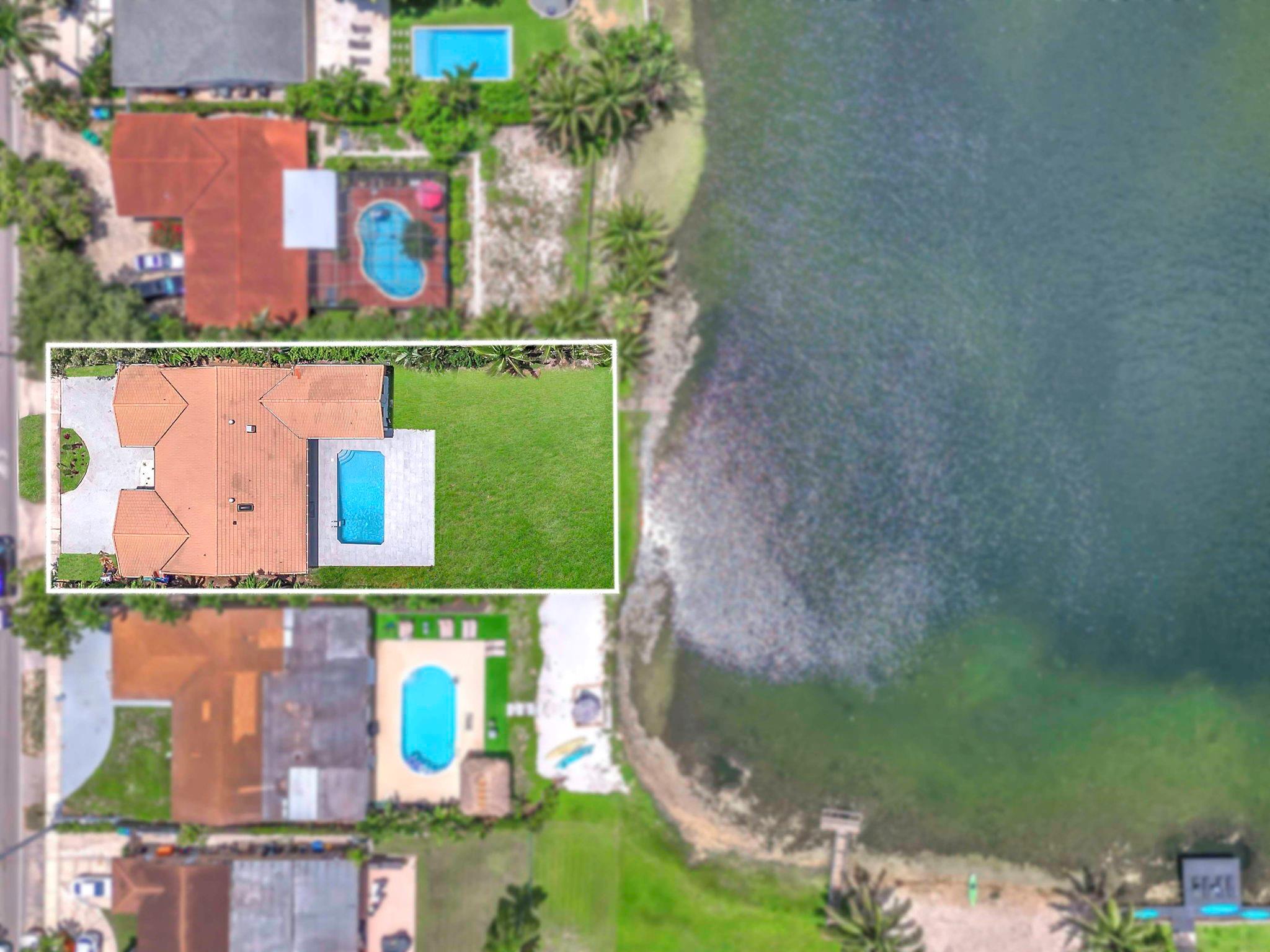 This stunning lakefront home blends luxury, efficiency, and smart tech with direct frontage on tranquil Greyknoll Lake—no HOA! Features include brand-new insulation, impact windows/doors, dual ACs, smart controls, and two water heaters. The chef’s kitchen boasts two 100” islands, double sinks, double Bosch dishwashers, and a 72” Monogram fridge/freezer with deluxe Shabbos mode. Includes dual ovens and an induction cooktop. Spa-like primary suite offers a soaking tub, 7’ rainfall shower, and smart commode. Gorgeous 40”x40” Italian porcelain tile throughout, oversized pool, tropical outdoor shower, EV charger, reverse osmosis system, and lake-fed irrigation.