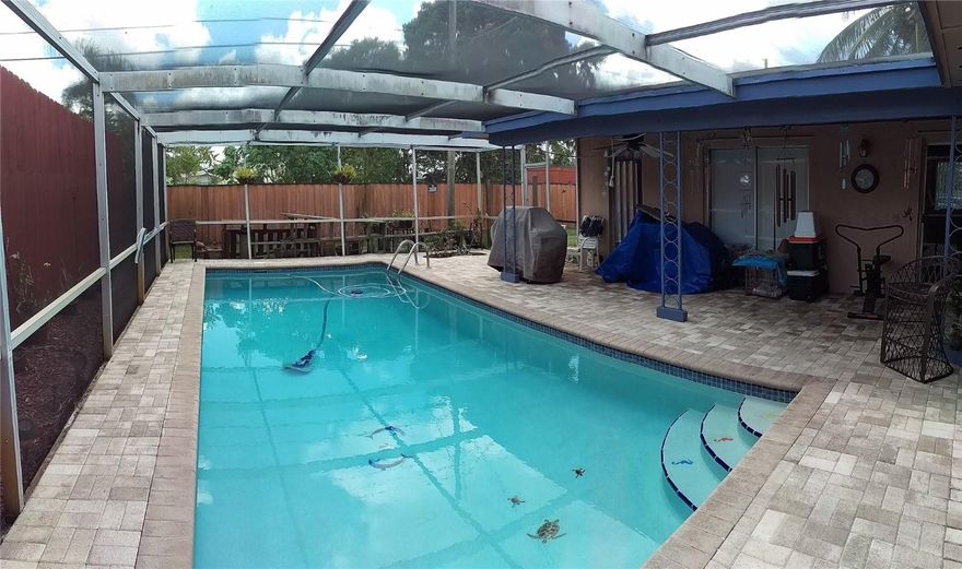 Beautiful Pool Home. Pool area is completely screen enclosed with patio area for entertaining around the pool. 3/2 home with open floor plan.  yard is completely fenced with new privacy fence.  Yard has 3 mature mango trees so you can enjoy your own organic fruit.  There are are also 2 coconut palms in front yard.  Yard is well maintained with zoned sprinkler system. House has aluminium hurricane shutters. Easy access to major roadways from the quite neighborhood.  Home is located between I-95 and I-75