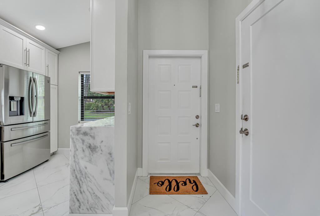 ONE IN A MILLION! THIS ONE IS A REAL JAWDROPPER!! A BRAND NEW SHOWPLACE FOR THE PRICE OF A RESALE! EVERYTHING IS NEW. ALL IMPACT WINDOWS, NEW INTERIOR INCLUDING FLOORS, SOLID CORE DOORS, KITCHEN, 2 NEW BATHS (PRIMARY BATH IS RECONFIGURED AND STUNNING WITH FREE STANDING TUB, CUSTOM LIGHTED MIRRORS, APPLIANCES, A/C, HOT WATER HEATER, PATIO WITH NEW EXTENDED PAVERS, FENCE, POSSIBLE OWNER FINANCING WITH LARGE DOWN PAYMENT! Whisper Walk is a gated community in a park-like setting with lush landscaping, lakes & tennis center including pickle ball, handball/paddleball & basketball courts;. Eastgate has it's own clubhouse with shows, events, exercise room, library, billiards, hot tub and heated pool. High speed internet, cable & water are included in the maintenance fee which is paid quarterly
