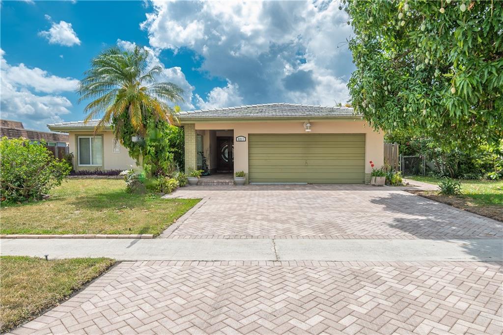 Located in the highly desirable Sunflower community of Tamarac. Hurricane windows and doors throughout. Split A/C system. 2 Car garage is converted into a large living area plus extra storage - can be converted back. This community has an HOA with a small $140/year fee and does not require HOA approval. There are no rental or pet restrictions. The association includes maintenance of common grounds around lake, a community pool, two parks, a playground, tennis court, racquetball court, and basketball court.