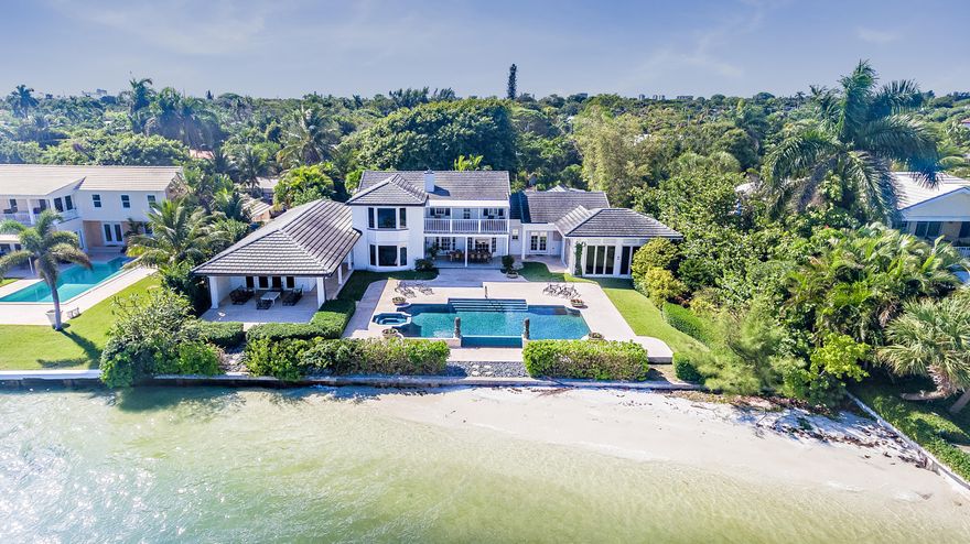 DIRECT INTRACOASTAL DREAM! Located on a sprawling 27,000+ sq ft lot, this property is a boaters paradise. Boasting Riparian rights and the ability to build a deep water dock, this lovely 4 bedroom, 4.5 bathroom home is close to the Palm Beach Inlet and ideal for boating enthusiasts as well as ocean lovers craving the crystal-clear water of Peanut Island and the nearby Atlantic Ocean. The infinity pool and sun-drenched private white-sand beach only further elevate the property's desirability.. With stunning views of Palm Beach from every angle, the 6483 square foot house offers fully-renovated chefs kitchen with eat-in dining,  impact windows, light-filled rooms with generous proportions, an expansive master suite, garage, and lovely outdoor spaces perfect for entertaining.A Must-See