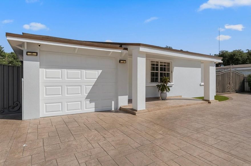 Seller Motivated!  Beautifully updated 3/2 single family home lovingly owned for over 15 years with No HOA.  Fully remodeled throughout with newer partial roof, A/C, and water heater (2022).  Spacious 10,000+ sq ft lot offers a huge backyard, an open canvas to design your own oasis.  This home greets you with impressive curb appeal, featuring a beautifully designed circular driveway and wrought-iron gated entrance that offers both elegance and added privacy.  Home also includes a versatile mother-in-law suite featuring its own kitchenette and bathroom, with private exterior entrance, can also be accessed within with the removal of the wall covering.Warm, cozy, and move-in ready, to make this lovely home yours!  Bring your offers, Seller ready for negotiations.