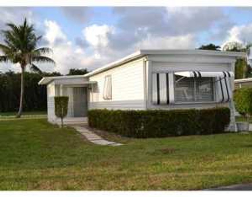 2/2 single wide coach in popular West Lakes of Boca Raton, a 55+ Coop mobile home community. Newer kitchen, newer bathrooms, newer floors, just move in! Perfect for a seasonal retreat or year round Florida living!! The kitchen features beautiful white raised panel cabinets, tile counters and backsplash and ample high hat lighting. Appliances include, smooth top stove, side by side refrigerator, built in microwave and dishwasher. Laminate wood floors in living and bedroom areas, and beautiful stone look tile in both bathrooms.