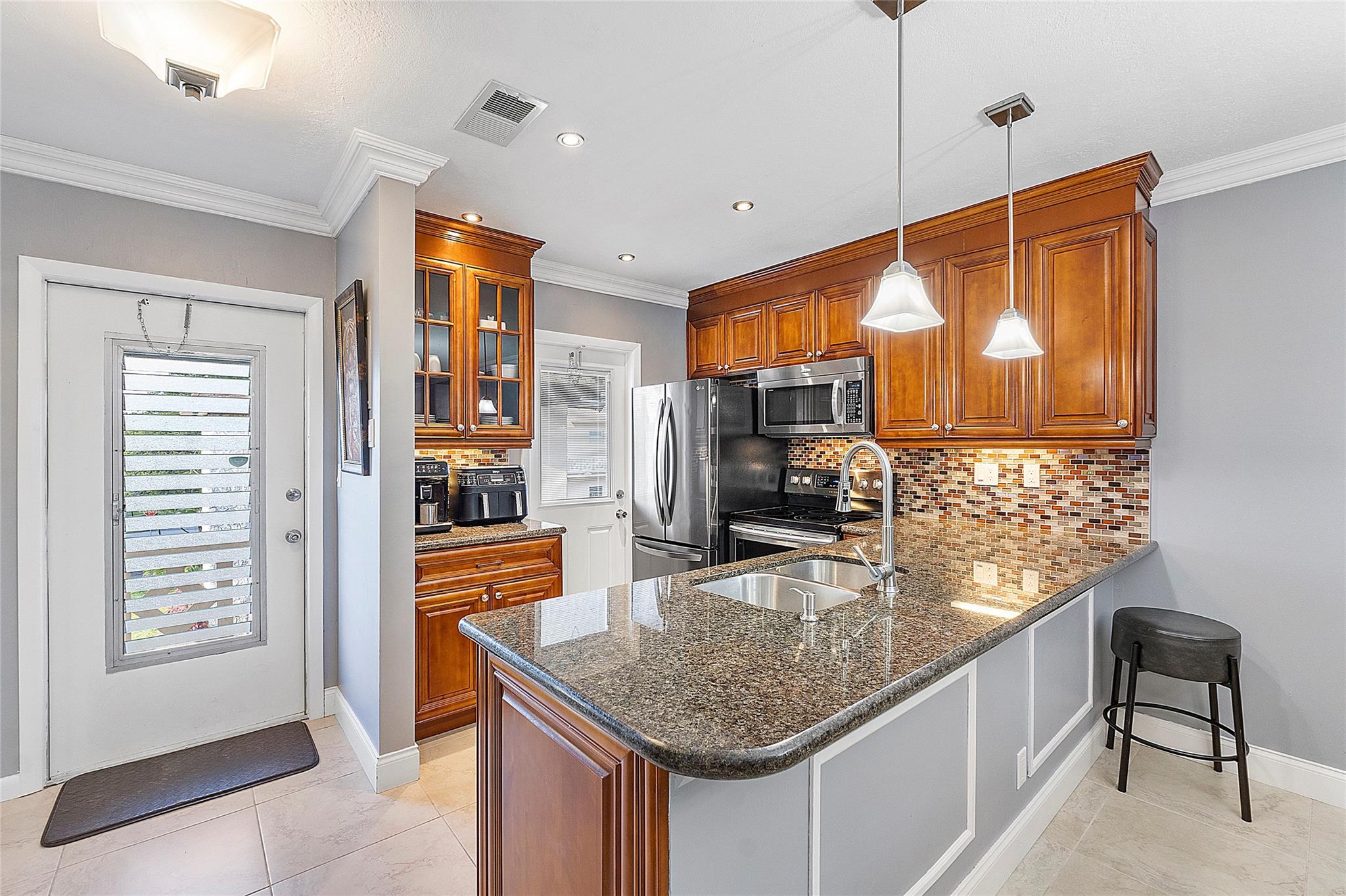This fully updated and furnished 2/2 unit offers a stunning water and garden view. The open kitchen boasts granite countertops and stainless steel appliances. With tile flooring throughout, the unit also features a recently replaced water heater in 2022 and an AC unit from 2019, ensuring comfort and efficiency. Residents can enjoy the amenities of the community, including a heated pool, shuffleboard, clubhouse, and BBQ area. Conveniently located near shopping, restaurants, hospitals, and transportation.