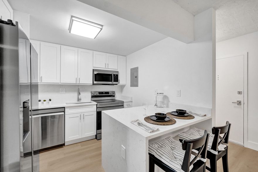 Fully renovated modern 1BR/1.5BA in Omega 4 with EVERYTHING NEW! Highly sought-after quiet 3rd floor north side location. Kitchen features quartz countertops and top-of-the-line Samsung stainless steel, low-profile appliances. Spacious layout with large living area and separate dining. Luxury vinyl flooring throughout. Brand new master bath with floor-to-ceiling porcelain tile and glass-enclosed tub/shower plus updated half bath. Screened balcony with green tree views, new tile, fan and lighting. Brand new central A/C with sleek vents. Ample storage with walk-in closet. 1 assigned parking plus guest parking. Amenities include pool, jacuzzi, tennis court, gym and clubhouse. Pet-friendly. ONLY building allowing immediate rentals (12-month min). Great investment!