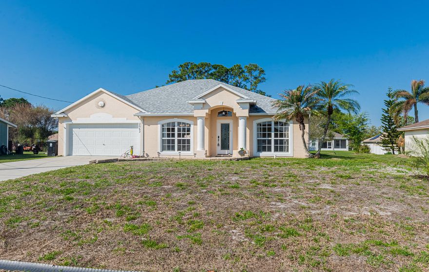 Welcome to your tropical oasis in Port St. Lucie! This meticulously maintained 3-bedroom, 2-bathroom, 2-car garage home offers the perfect blend of comfort and Florida elegance. Step inside to discover a bright and airy open floor plan featuring beautiful tile flooring throughout—no carpet here! The heart of the home is a spacious kitchen designed for entertaining, complete with sleek Corian countertops, stainless steel appliances, and a functional center work island.  Slide open the doors to your private outdoor retreat. The expansive covered lanai leads to a stunning screened-in, heated pool featuring a relaxing spillway spa. Whether you're hosting a summer BBQ or enjoying a quiet morning coffee, this backyard setup is a dream.  2022 Roof & 2022 Pool Heater.  Great location!