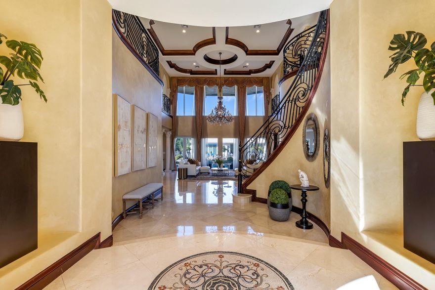 Fully furnished and move-in ready! This custom 5 bed + optional 6th bed, 6 bath waterfront estate is located on a deep water canal just two lots off the intracoastal canal. Enter through the Chicago brick circular driveway and oversized mahogany Renaissance wood carved front door, and be greeted by a wrought iron spiral staircase and polished marble floors. The chef's kitchen features granite countertops, oversized island, top of the line SS appliances, & beverage center perfect for entertaining. Primary bedroom features a spacious sitting area, custom California closets, dual vanity bathroom, and private covered balcony. Backyard boasts 90ft of water frontage and dockage, 20,000 lb elevator boat lift, composite wood dock, heated swimming pool and spa, and summer kitchen. Also for rent.