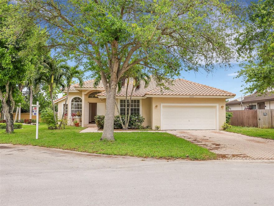 Beautiful home nestled in a lovely community in the heart of Coral Springs. Mature tree lined streets lead you home. The large kitchen with an eat in breakfast area and pantry is perfect to create your culinary masterpieces. Formal living room and a unique attractive formal dining room which can also be used for any creative purpose. Beautiful mexican tile throughout living areas. Don't miss the authentic dog paw prints. (See if you can find them!) Large master bedroom. Master bath with dual sinks, separate shower and luxurious roman tub. Freshly painted interior and exterior. New French Doors. New carpet in one bedroom. Full size washer and dryer inside the home. Two car garage. Paver driveway. Backyard patio with no residential neighbors behind for privacy. Close to dining and shopping!!