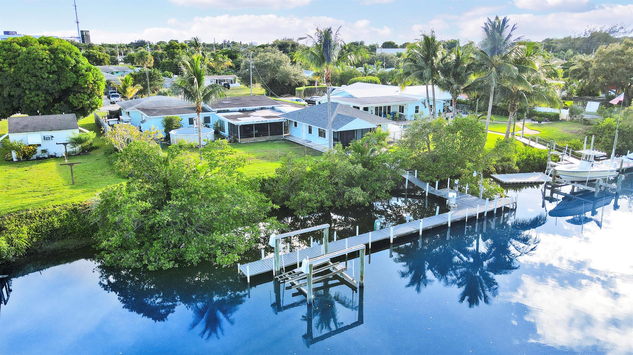 Welcome to your coastal escape! This property features a 3-bedroom, 2-bath main house and a cozy 2-bedroom, 1-bath guest house on a serene canal with 100 feet of water access.The main house boasts an open-concept living area with large windows that provide natural light and peaceful views. Enjoy meals in the dining space or on the Patio overlooking the canal. The master suite offers a relaxing retreat, alongside two additional bedrooms.The guest house includes a full kitchen and living area, providing privacy for visitors. With a beautifully landscaped yard, this property is perfect for outdoor gatherings. Conveniently located near shops & restaurants. this Ocean-Access retreat is ideal coastal living.With accepted terms and successful Closing. Gift of a Golf Cart given to the buyers!!