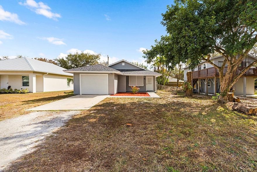 Central Vero Beach location close to the highway, airport, shopping & dining with NO HOA! This beautifully remodeled 2 bedroom, 2 bathroom + oversized 1 car garage home features a modern eat-in kitchen with quartz counter tops, crisp white cabinets, 4 inch quartz backsplash & stainless steel appliances. Freshly painted inside & out with new floors throughout, new baseboards, LED lighting, stylish fixtures & fans in every room. Enjoy remodeled bathrooms with custom finishes. This home is complete with a new roof (2026), AC (2020). Short drive to the beach!