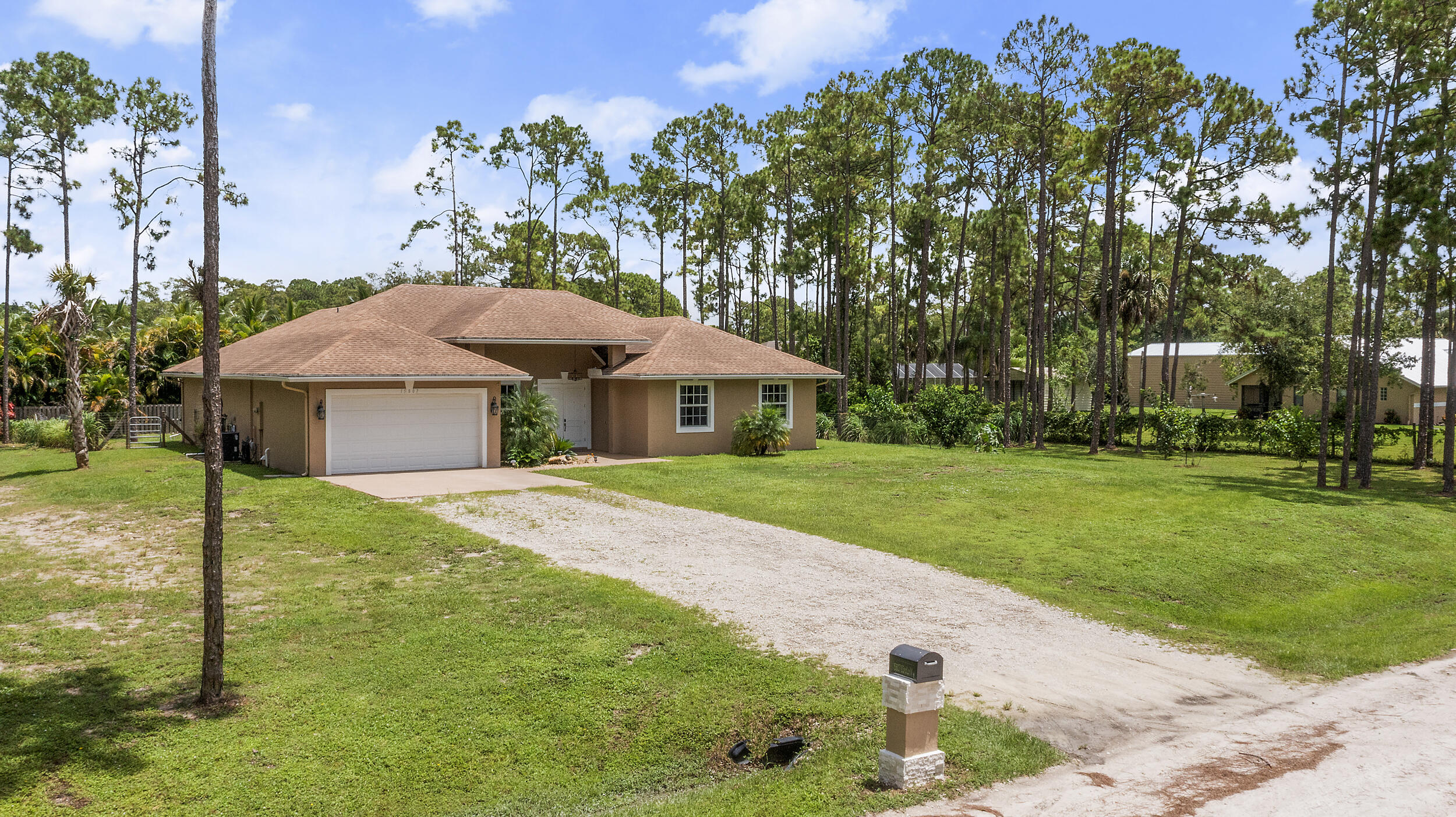 **BUILT IN 2019 ON 1.15 ACRES** Welcome to 15807 83rd Ln N in Loxahatchee, FL -- a beautifully updated 4-bedroom, 2-bathroom home ideally located just off Northlake Blvd, offering both convenience and privacy. Inside, you'll find engineered waterproof wood flooring throughout, 8-foot doors, and impact windows that provide a modern, durable touch. The spacious white kitchen is a true highlight, featuring under-cabinet lighting, pull-out shelving in the pantry, and a layout perfect for both everyday use and entertaining. The guest bathroom offers a double vanity, while the private master suite boasts sliding doors to the backyard, a luxurious ensuite with a soaking tub, walk-in shower, and dual sinks.