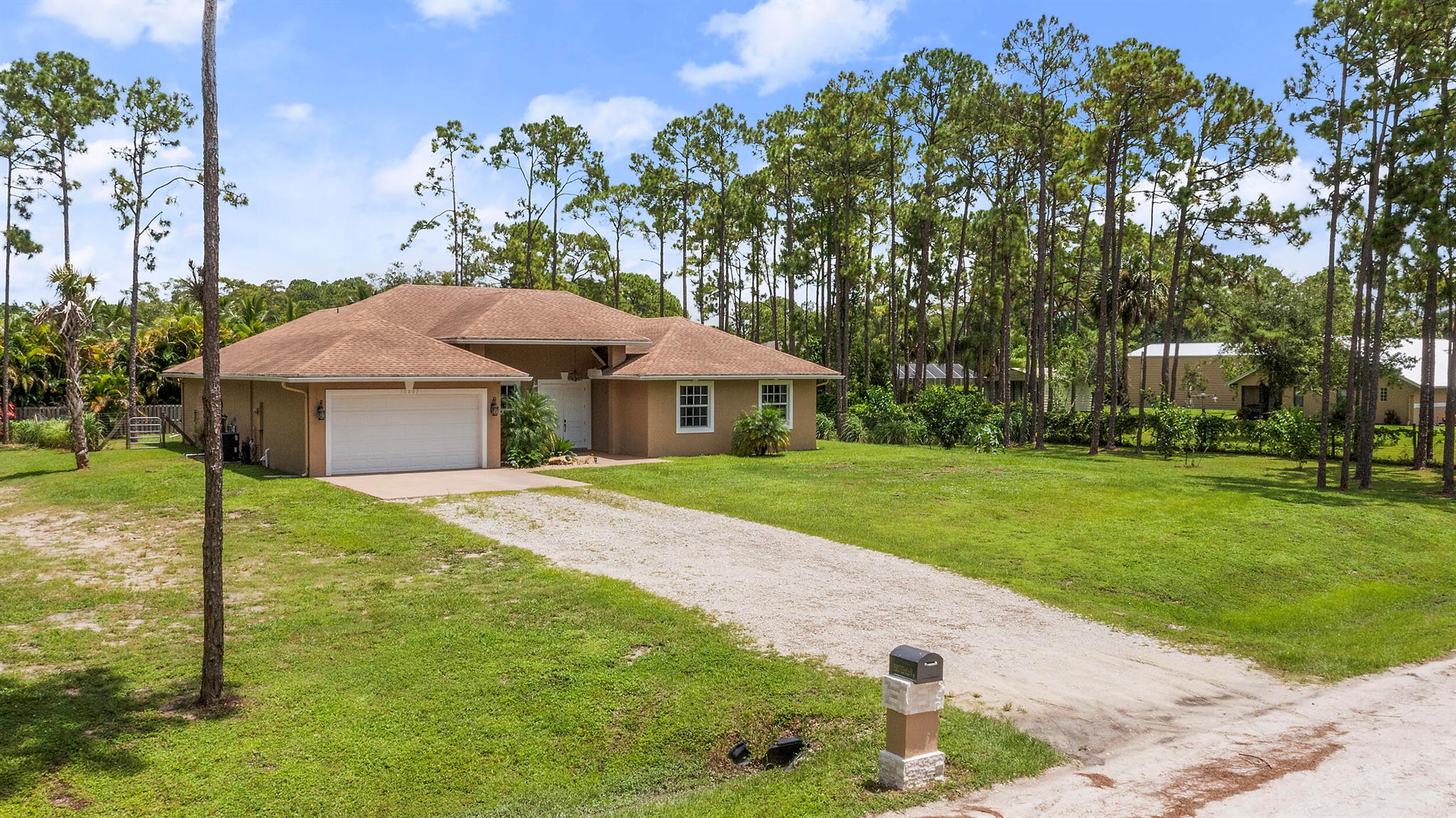 **BUILT IN 2019 ON 1.15 ACRES** Welcome to 15807 83rd Ln N in Loxahatchee, FL -- a beautifully updated 4-bedroom, 2-bathroom home ideally located just off Northlake Blvd, offering both convenience and privacy. Inside, you'll find engineered waterproof wood flooring throughout, 8-foot doors, and impact windows that provide a modern, durable touch. The spacious white kitchen is a true highlight, featuring under-cabinet lighting, pull-out shelving in the pantry, and a layout perfect for both everyday use and entertaining. The guest bathroom offers a double vanity, while the private master suite boasts sliding doors to the backyard, a luxurious ensuite with a soaking tub, walk-in shower, and dual sinks.