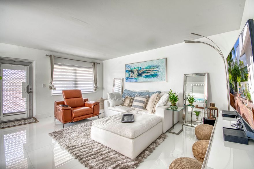 Beautifully remodeled 2BR/1.5BA upstairs corner condo with water views in the gated 55+ community of Century Village in West Palm Beach. Corner location provides water views from the side and rear of the unit.
Modern tile floors flow seamlessly through the living spaces, bedrooms, and primary bath. The main living area connects to the dining space with zebra shades and an updated kitchen featuring blue painted wood cabinetry, quartz countertops, stainless steel appliances, and a window. The rear of the condo includes two bedrooms and 1.5 baths. The primary suite offers sliding glass doors to the screened balcony and a walk-in closet with motion-sensor lighting. The updated bathroom includes a glass shower door, vanity, modern lighting, and contemporary finishes. The guest bedroom mirrored closet doors and a window overlooking the balcony and water. The screened balcony spans the full width of the condo, with water views and added privacy due to the corner position.

Upgrades and features include: new flooring, fresh paint, popcorn ceilings removed, painted cabinets, quartz counters, new window sills, updated interior doors, baseboards throughout, modern light fixtures, new glass shower door, lighted bath mirrors, new vanity, serviced A/C units, and window treatments, impact windows.

Century Village amenities include a 92,000 sq ft clubhouse, 1,221-seat theater, fitness center, wave-walking pool, classes, clubs, and social events, all minutes from Downtown West Palm Beach, PBIA, I-95 & Turnpike.