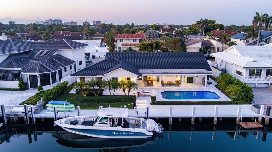 An idyllic lifestyle awaits at this Coastal Contemporary Deepwater Estate sited on 98’ of waterfrontage in the sought-after enclave of Lighthouse Point. Re-Imagined interiors reveal 4 beds, 3 baths & 2,635 +/- Living Sq. Ft. Impressive vaulted ceilings showcase the light filled interiors and open floorplan. Chef's kitchen with Sub-Zero & Wolf appliances is a culinary masterpiece. Other amenities include 2 Bay Garage, Impact Windows, 2 zone A/C, extensive renovation featuring updated kitchen & baths, porcelain flooring, new paint & stucco, landscape lighting, pool deck & more. Outdoor entertainment is enjoyed at the large, covered lanai and sun-splashed pool. For boating enthusiasts, there is an updated full service 98’+/- concrete yacht dock just minutes from the Hillsboro Inlet.