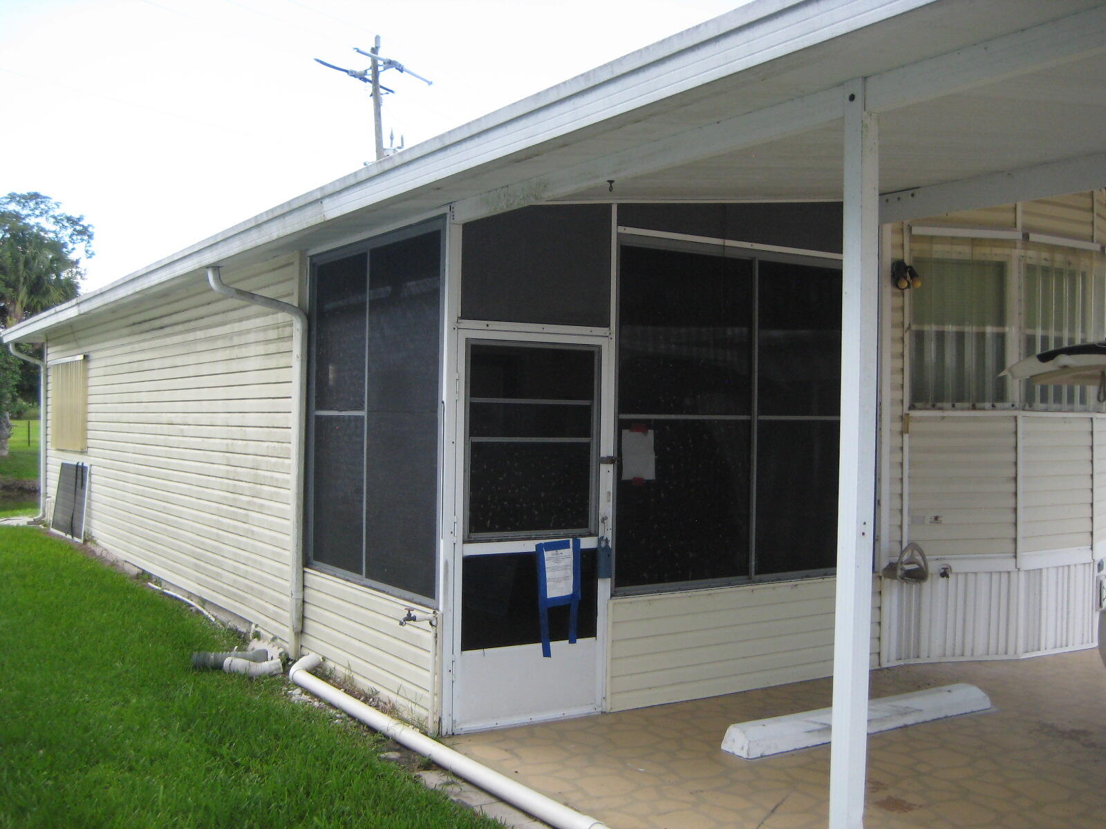 Manufactured home in the desirable 55+ gated community of Ancient Oaks RV Resort in Okeechobee, featuring an enclosed patio for extra living space, serene pond views, and backyard privacy. You own the land it is on. Low HOA fees (under $220/month) include water, sewer, cable, lawn care, clubhouse, pool, and more. Community amenities, a heated pool & spa, marina with boat docks and ramp, shuffleboard, laundry facilities, recreational hall with library, bingo nights, and a fitness room. Storm shutters provide added peace of mind, making this an ideal seasonal retreat or year-round residence. Buyer to verify all MLS information, measurements and HOA information.