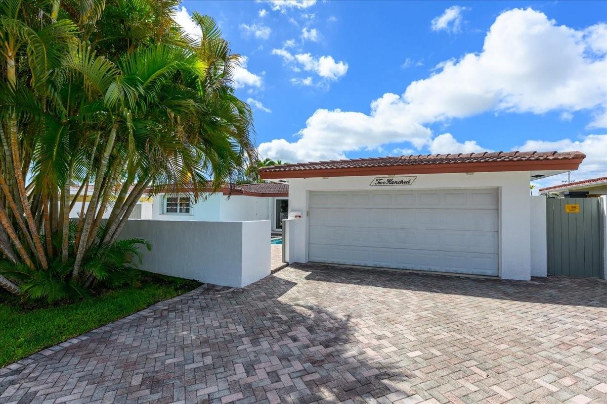 Luxury Waterfront Home w/Ocean Access! This meticulously maintained 3BR/2BA 2-car garage, with new exterior paint, paver driveway, and concrete privacy fencing. Oasis private entrance to a gas-heated swimming pool & patio. Custom open kitchen w/ extra storage, Wet bar/water filter, wine + beverage coolers, 2 garbage disposals, perfect for entertaining. The split floor plan offers comfort and privacy. Additional upgrades include a custom air-conditioned utility rm w/ cabinets & deep freezer, accordion hurricane shutters, updated A/C, full CAT wiring, & surround sound system. Out back, expansive paver deck with stylish steps leads to the canal, offering seamless water access. Located in a desirable waterfront community, this home is move-in ready and delivers true luxury coastal living.