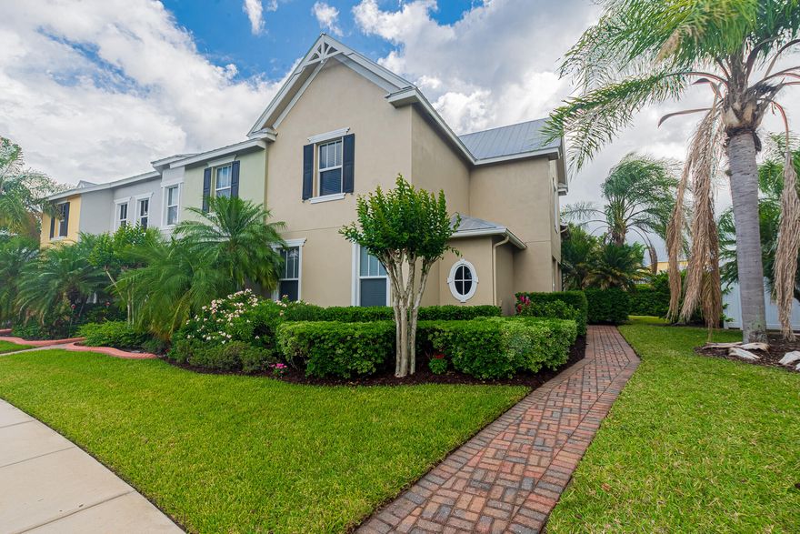 Discover effortless living in Bedford Park with this beautifully upgraded 3BR/2.5BA CBS corner townhome offering privacy and style. Lush landscaping and 6-ft hedges create a serene setting, while inside you'll find 20x20 tile, plush carpet, impact windows, and a bright, open layout. The modern kitchen features quartzite countertops, 42" cabinetry, and stainless appliances. Enjoy the convenience of a first-floor primary suite and laundry, plus a versatile upstairs loft—perfect for a home office or flex space. New A/C (2025) adds peace of mind. Across from the community pool and a block to Butterfly Park. Walk to Tradition Square dining, shopping, and more. Near I-95—HOA covers cable, internet, lawn care, exterior maintenance &Pest control. Schedule your showing today!