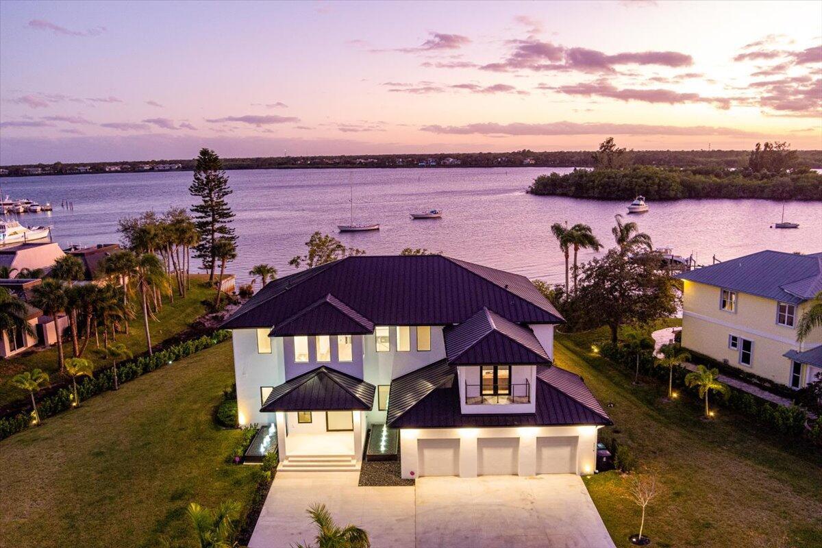 An Absolute Stunning Ocean Access Waterfront Estate sitting on a Sprawling 1.5 Acres! This Practically New 4BR 3.5BA (Home Completed May 2024), Modern Contemporary Gem Backs up to a Bay on The North Fork of the St Lucie River with absolute stunning views of the water! Located in Beautiful River Vista, this is An Excellent Opportunity to have your Custom Dock Installed and have your boat waiting for you in your backyard. Walking in you will instantly notice the Architecturally Clean Lines throughout. This Estate home features Two Master Suits, a Home Gym, Movie Room, Custom Closets, Heated Salt Pool and Spa, Sleek Kitchen with Thermador Appliances. So many Possibilities for this oversized property, Including multi-car garage, tennis Court or In-Law suite. This Home is absolute Must See!