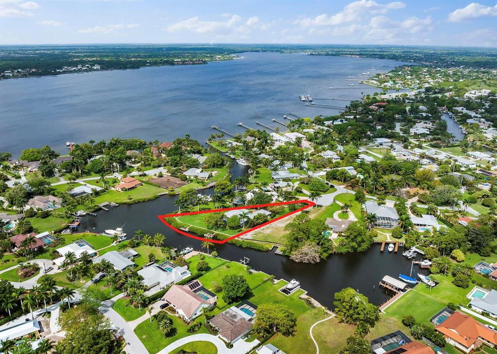 Stunning 4 bedroom, 3.5 bathroom CBS waterfront home with 182 feet of seawall. 2 composite docks with a 10,000 lb boat lift. Deep water access with no fixed bridges, so bring your biggest boat! This custom home has all the bells and whistles; upon entering through Borano true-mahogany front doors you are greeted to a spacious and open floor plan. In the kitchen you will find Fieldstone cabinetry by Chad Akers Cabinets, granite countertops, Electrolux refrigerator, Thermador cooktop, oven, microwave, & dishwasher. Plantation shutters adorn the interior windows throughout the home. The primary bedroom and bathroom is tranquil and spa-like, with coffered ceilings, sliders to the patio, a massive walk-in closet, dual vanities, and spa tub. Cali-Bamboo solid wood flooring in bedrooms. Impact po