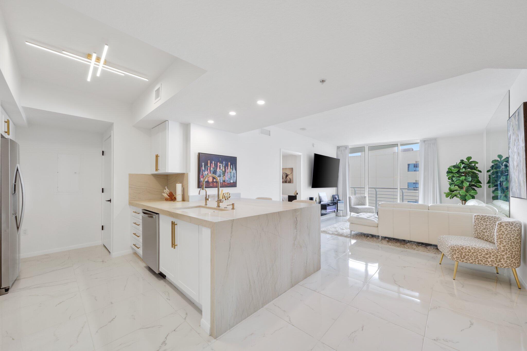 Experience luxury living in this beautifully updated 2-bed, 2-bath condo located in the heart of downtown West Palm Beach. Offered fully furnished, this condo boasts stunning intracoastal views from the southeastern facing balcony, a modern kitchen with natural stone quartzite countertops that have a sleek leather finish and brand-new solid wood shaker cabinets. Enjoy porcelain tile flooring throughout, frameless shower doors, and blackout shades. Not to mention shutters in the bedrooms for added comfort. One covered, gated garage parking space comes with the unit. Amenities include two pools - for sunrise and sunset, a business center, clubroom, gym, valet service, and 24-hour front desk attendant.