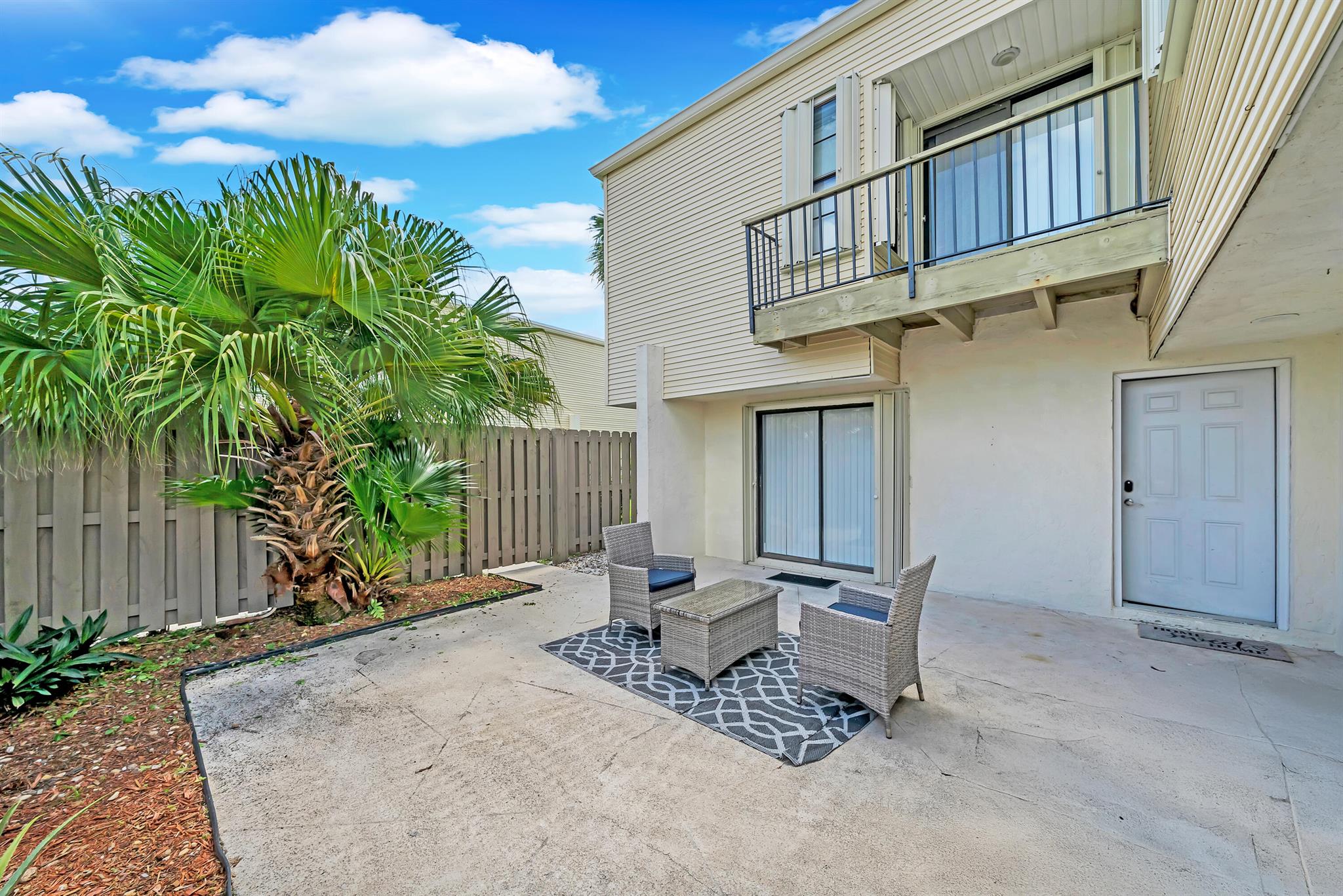Discover this beautifully renovated 2 BR, 2.5 BA townhome in the heart of Wellington--just four miles from the World Equestrian Center and within walking distance to Wellington Town Square--featuring modern finishes throughout, quartz countertops, new fixtures and appliances, two private master suites with ensuite baths, a bright open living area that flows to a spacious, fenced patio (fence installed 2022) perfect for entertaining, and a brand-new roof installed July 2025; sold fully furnished with furniture negotiable, in a quiet community with two assigned parking spaces right in front of townhome and moments from shopping, dining, parks, and equestrian venues.**Washer and dryer shown in photos do not convey; seller will replace to closing.**