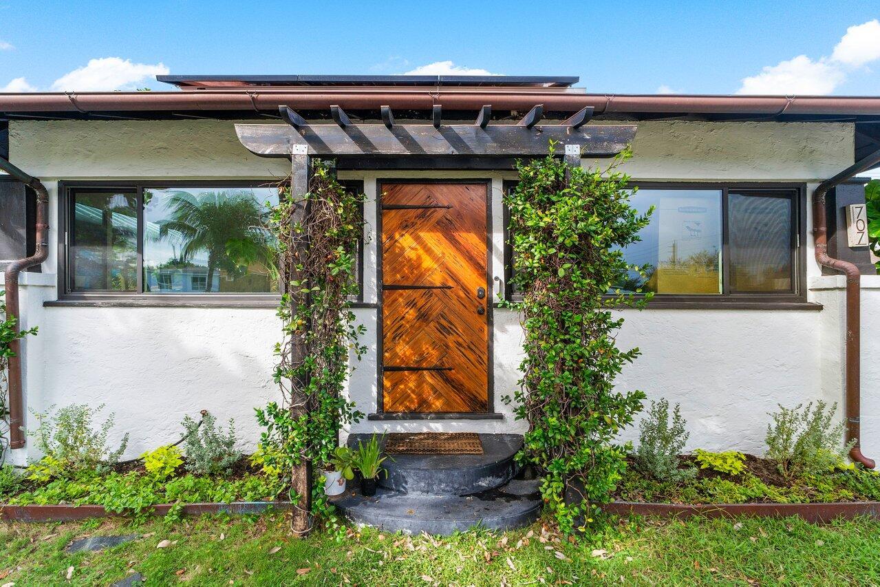 Price Adjustment! Explore this unique multi-family gem in West Palm Beach featuring 3 units total; the main house up front and a detached structure in the back with upper and lower units all 1 bed 1 bath, plus a large workshop space. Can't miss the Pecky Cypress front door on the main house and inside boasts original Dade County pine wood flooring, crown moulding, custom wood accents, impact windows, a new central AC, Nest thermostat, New tankless water heater, and an inviting upgraded kitchen with Stainless Steel appliances, custom hood vent, and a gas stove. Solar panels for energy savings! The two units out back are move-in ready, lower unit updated floor and bathroom, upper unit with wood floors, this is the perfect income producing investment or multi-generational living. See today!