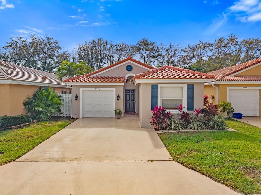 This 3-bedroom, 2-bath home with a 1-car garage is located in a gated golf community with no membership fee and features a bright, open floor plan designed to impress from the moment you enter. Meticulously maintained and in pristine condition, the home offers tile flooring throughout, vaulted ceilings, recessed lighting, and freshly painted interior and exterior walls. The roof was replaced in 2025, and the property is fully equipped with new hurricane-impact windows and doors. The upgraded kitchen includes stainless-steel Samsung appliances, a wine cooler, kitchen island, generous counter space, and stylish lighting, ideal for both everyday living and entertaining. The split-bedroom layout provides added privacy, with a unique barn door entry to the primary suite, featuring vaulted ceilings, a spacious walk-in closet, and a well-appointed bathroom. Enjoy outdoor living with a large covered and screened patio, along with an open patio and pergola overlooking the backyard.  Community amenities include a clubhouse, restaurant, golf course, tennis courts, swimming pool, fitness center, and children's play area. Conveniently located near excellent schools.